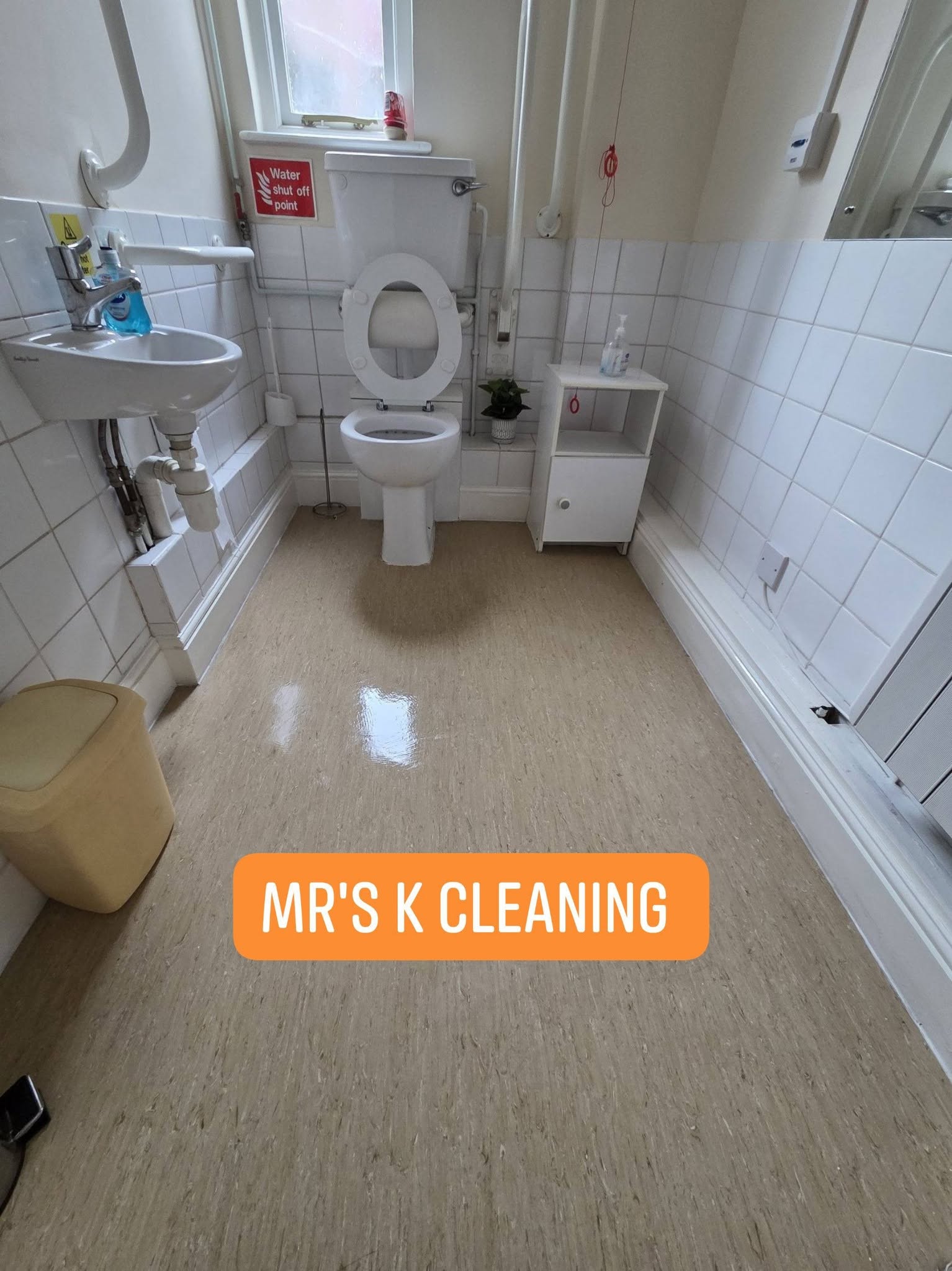 Bright commercial bathroom with white tiles