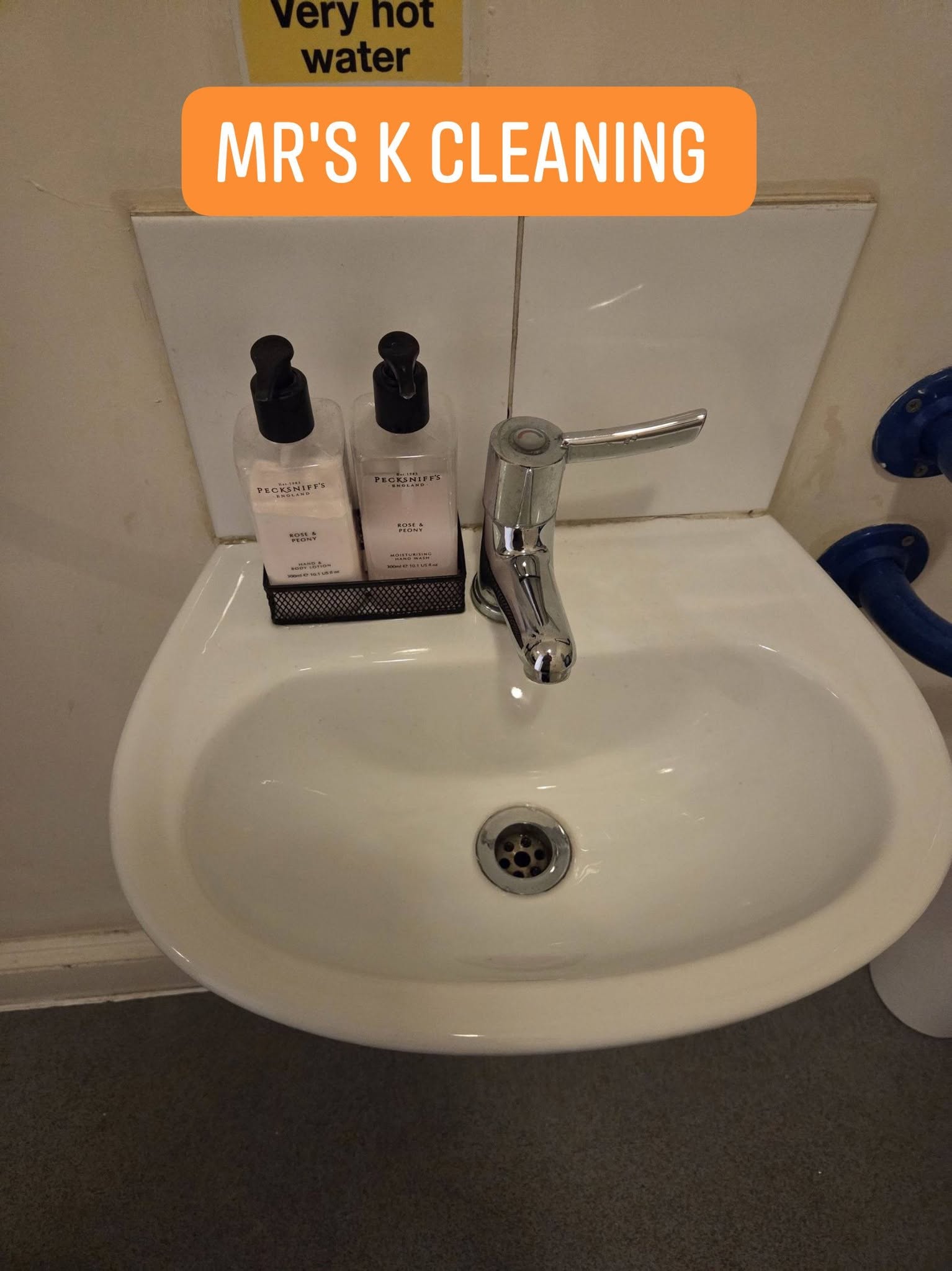 Clean bathroom sink with toiletries and faucet