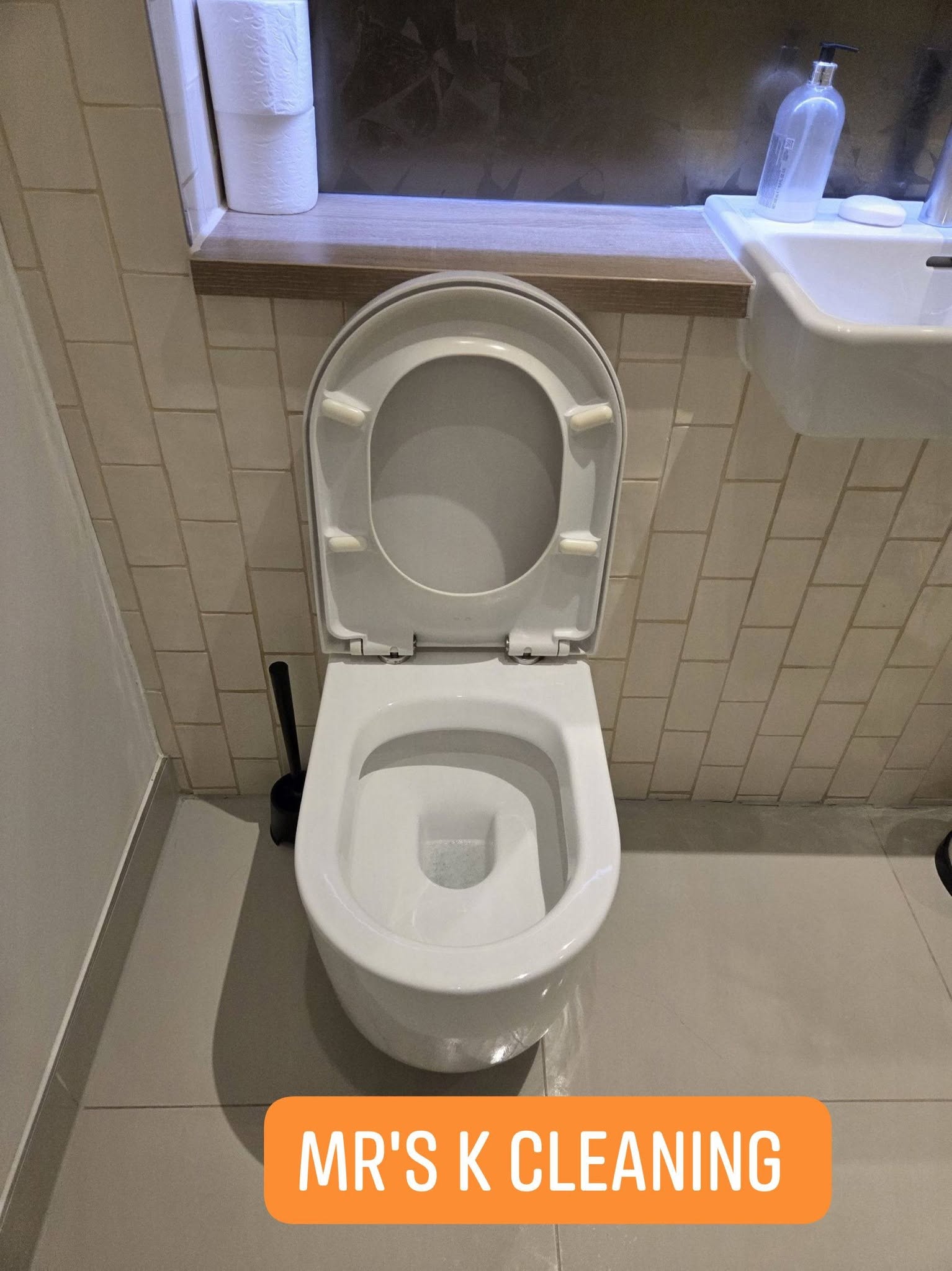 Clean white toilet with seat up