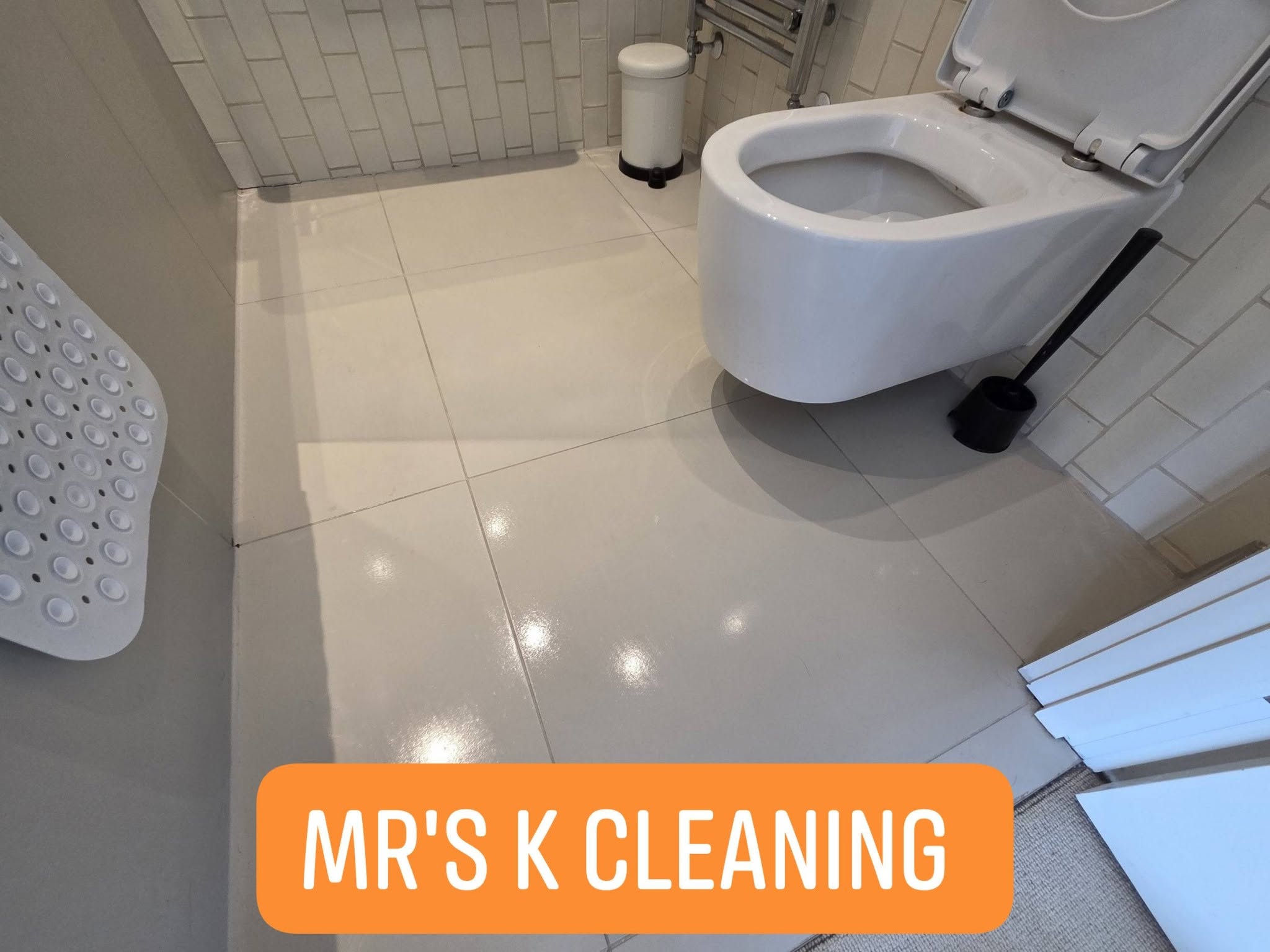 Clean white bathroom with tiled floor