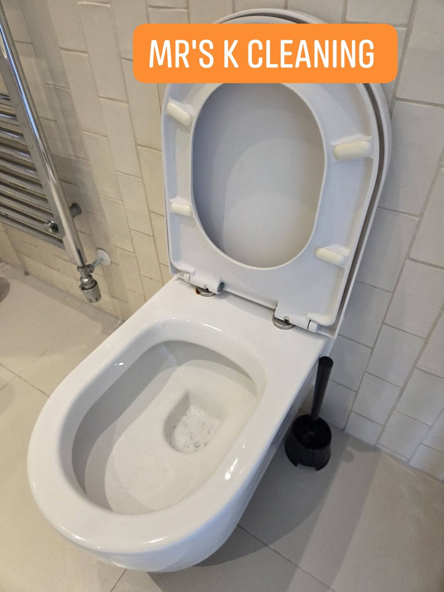 Clean white toilet bowl with open lid