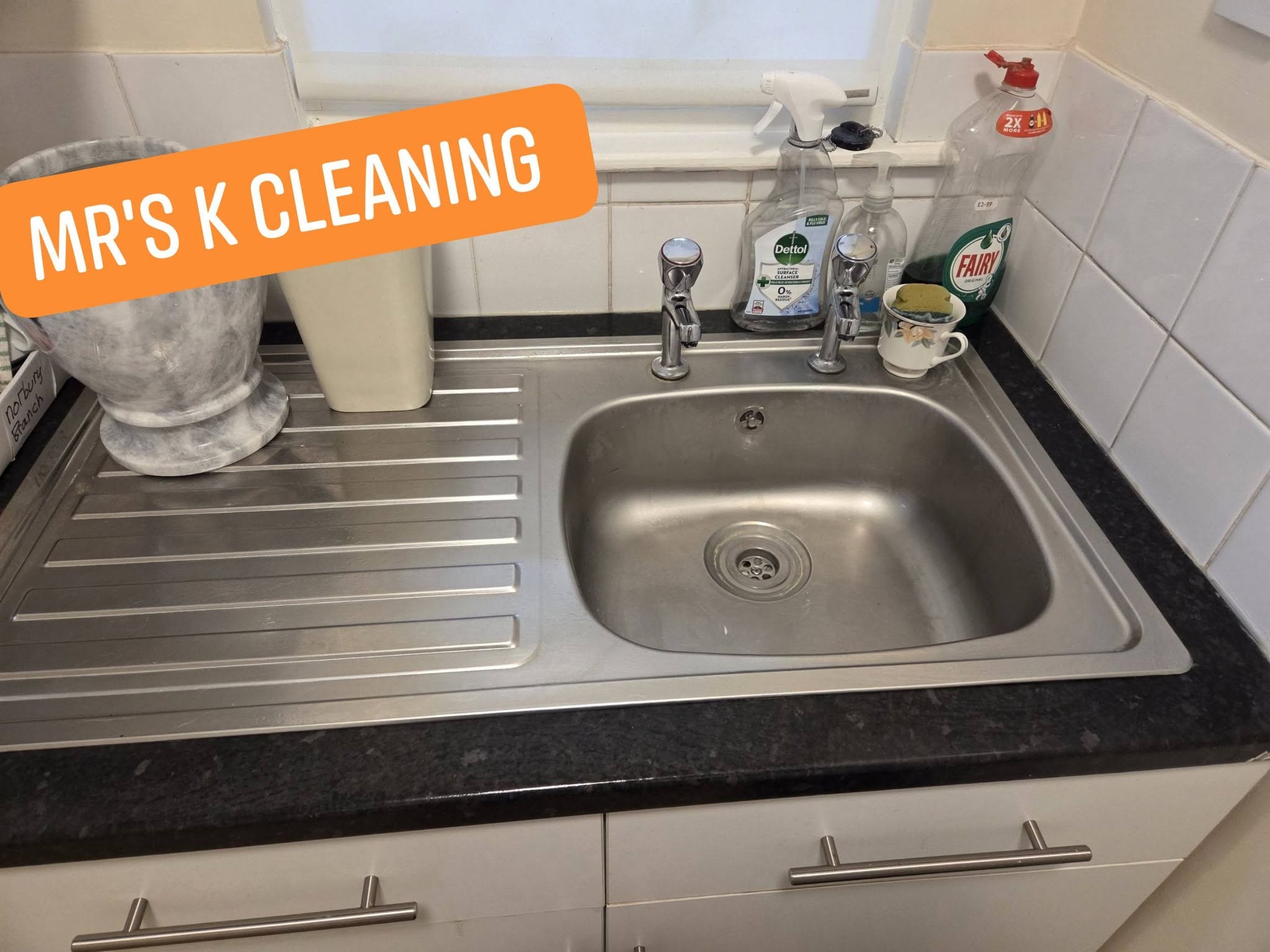 Clean kitchen sink with cleaning products