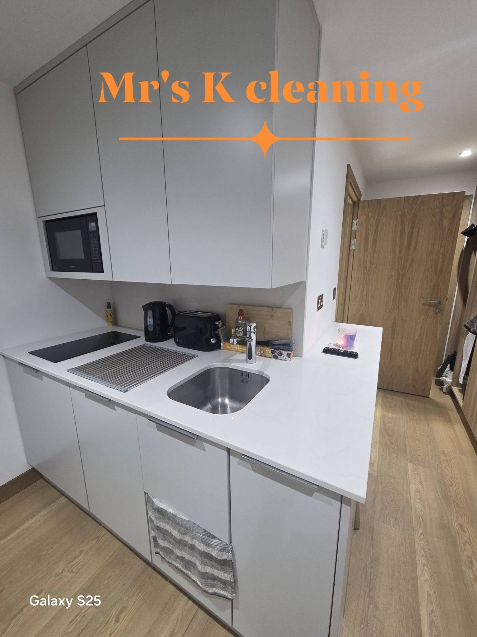 Clean modern white kitchen with sink and worktop
